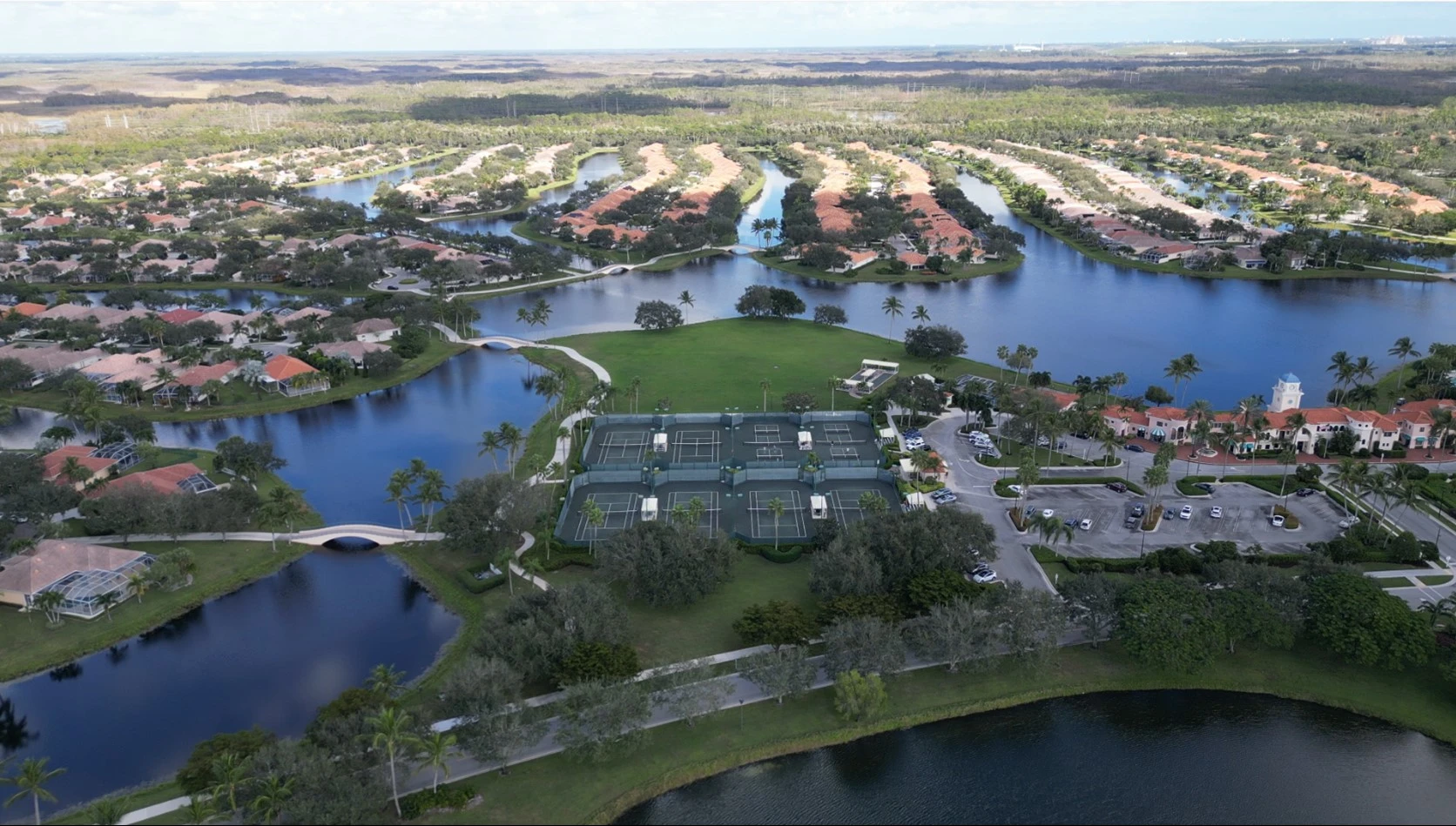 Aerial view of the RiverWalk clubhouse with Har-Tru tennis courts and pickleball courts in West Palm Beach