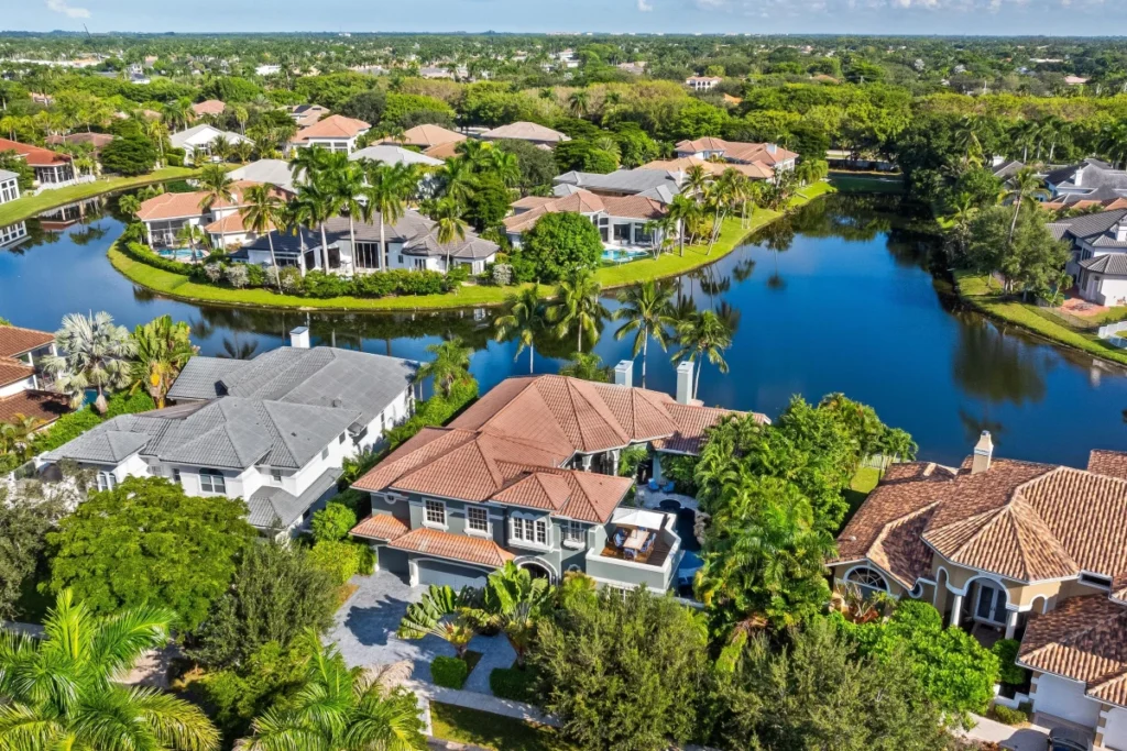 Luxury lakefront homes at The Seasons in Boca Raton with mature landscaping and waterfront views.