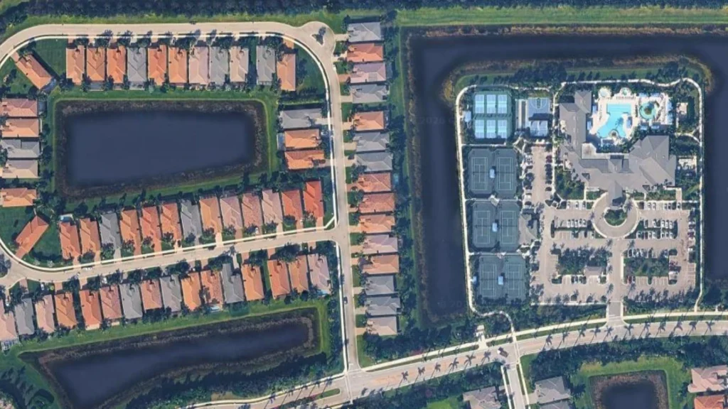 Aerial view of Valencia Bay in Boynton Beach showing the clubhouse, six Har-Tru tennis courts, pickleball courts, resort pool and 55+ community amenities.