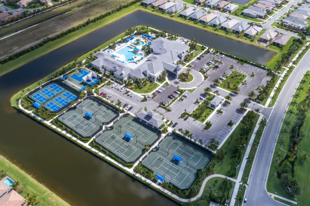 Aerial view of the Valencia Bay clubhouse, resort pool, Har-Tru tennis courts and pickleball courts.