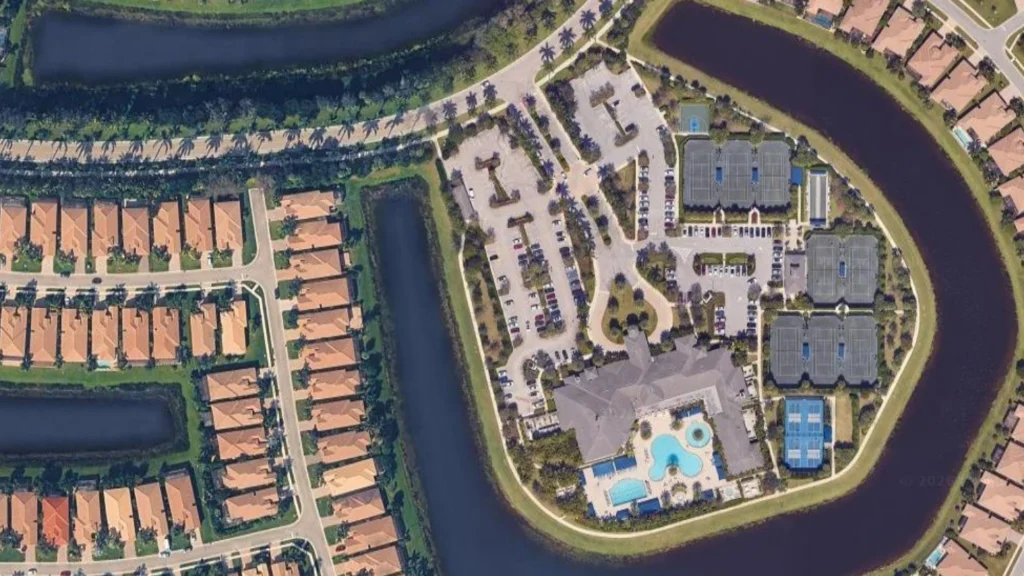 Aerial view of Valencia Cove clubhouse, Har-Tru tennis courts, pickleball courts, and resort amenities in Boynton Beach