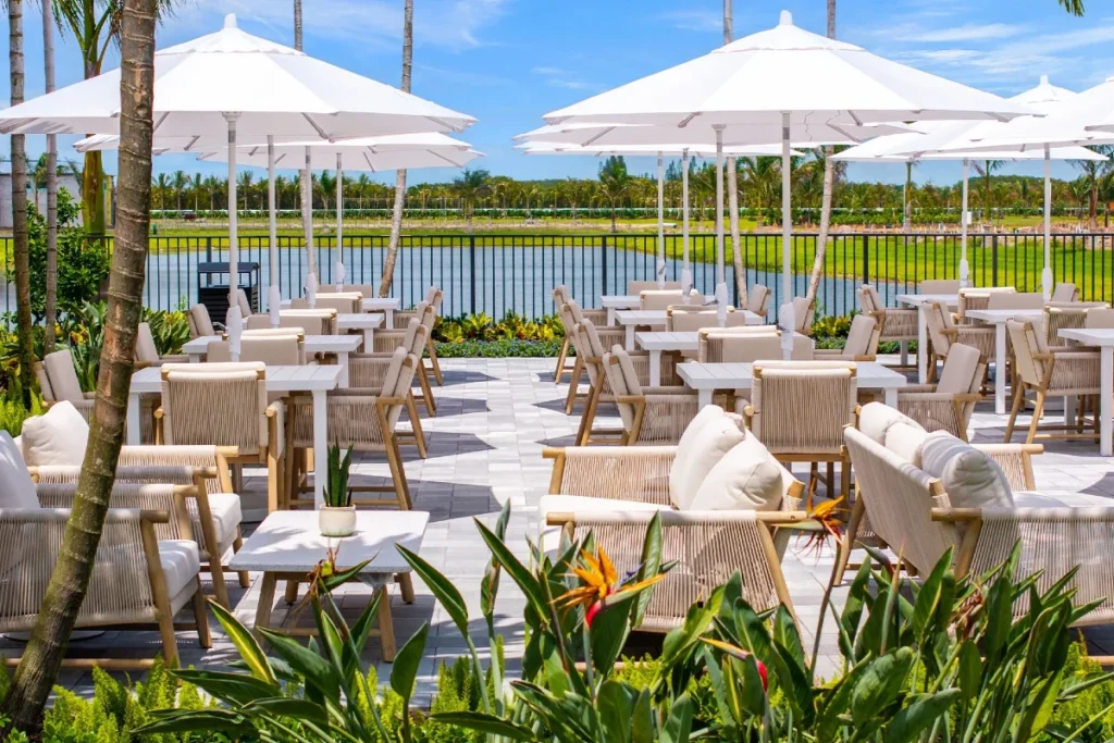 Outdoor dining terrace overlooking the lake at Valencia Del Mar in Boynton Beach.