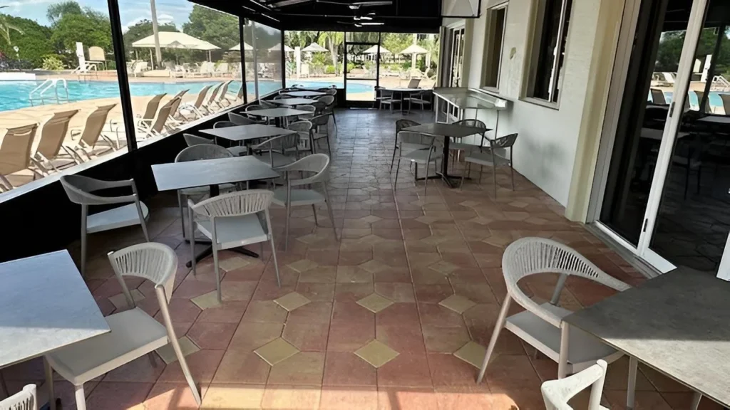 Covered poolside café seating beside the community pool at Valencia Falls in Delray Beach