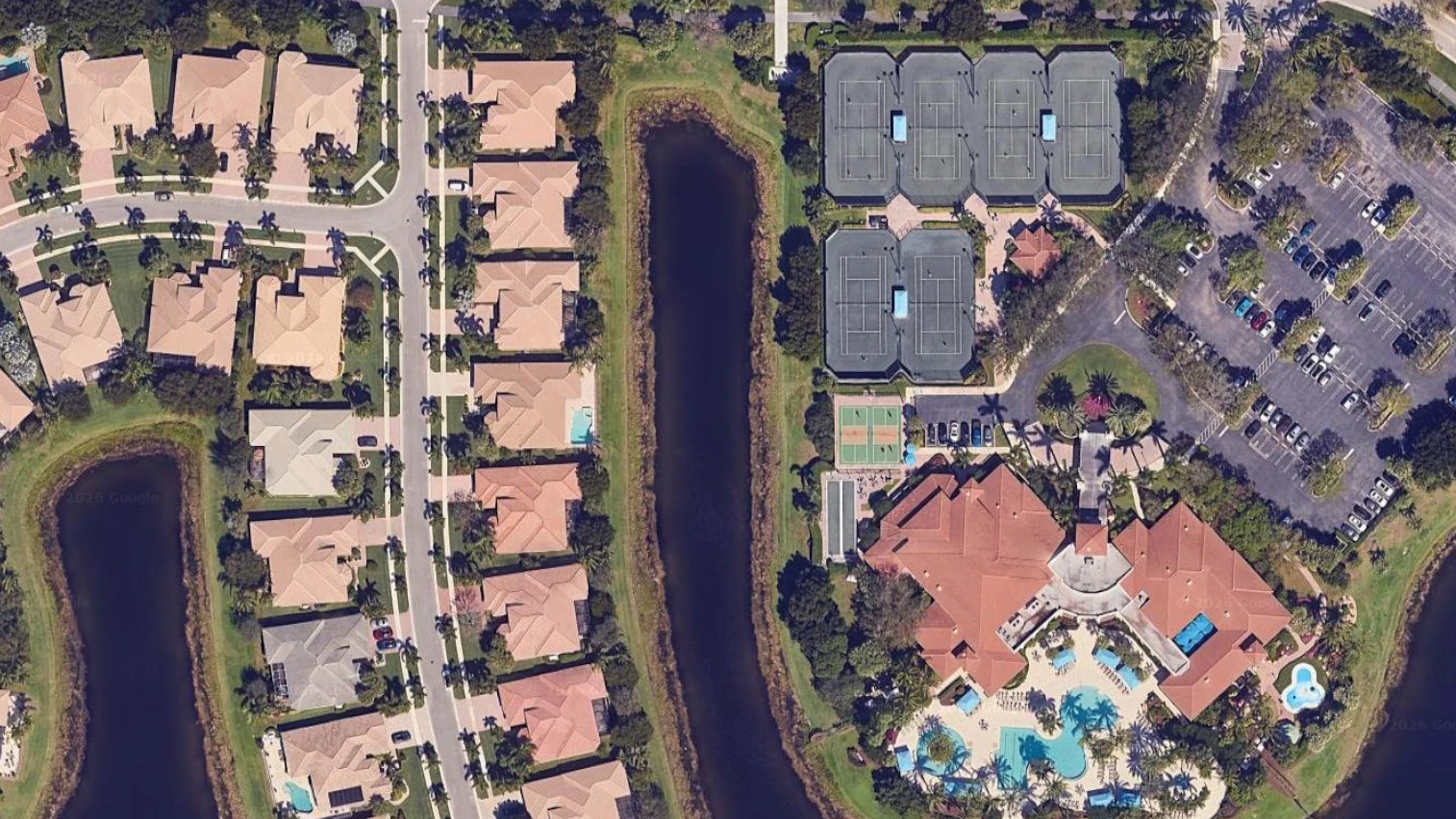 Aerial overview of Valencia Palms showing the clubhouse, six Har-Tru tennis courts, two pickleball courts, and surrounding homes in Delray Beach