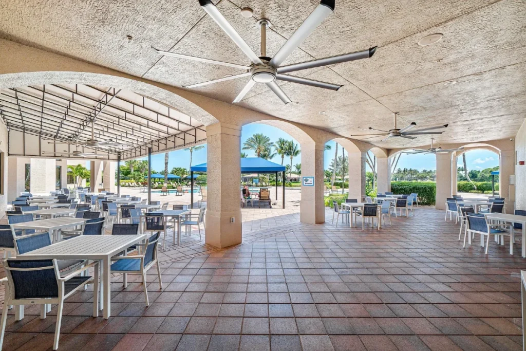 Outdoor dining patio overlooking the resort pool at Valencia Pointe clubhouse