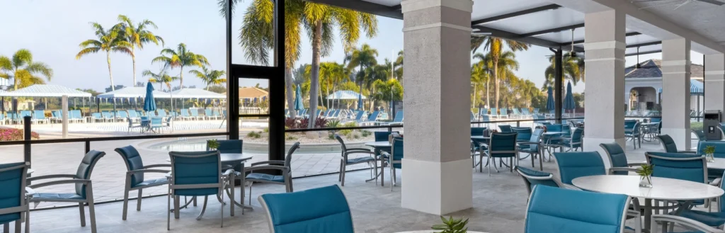 Covered outdoor dining terrace overlooking the resort pool at Valencia Reserve