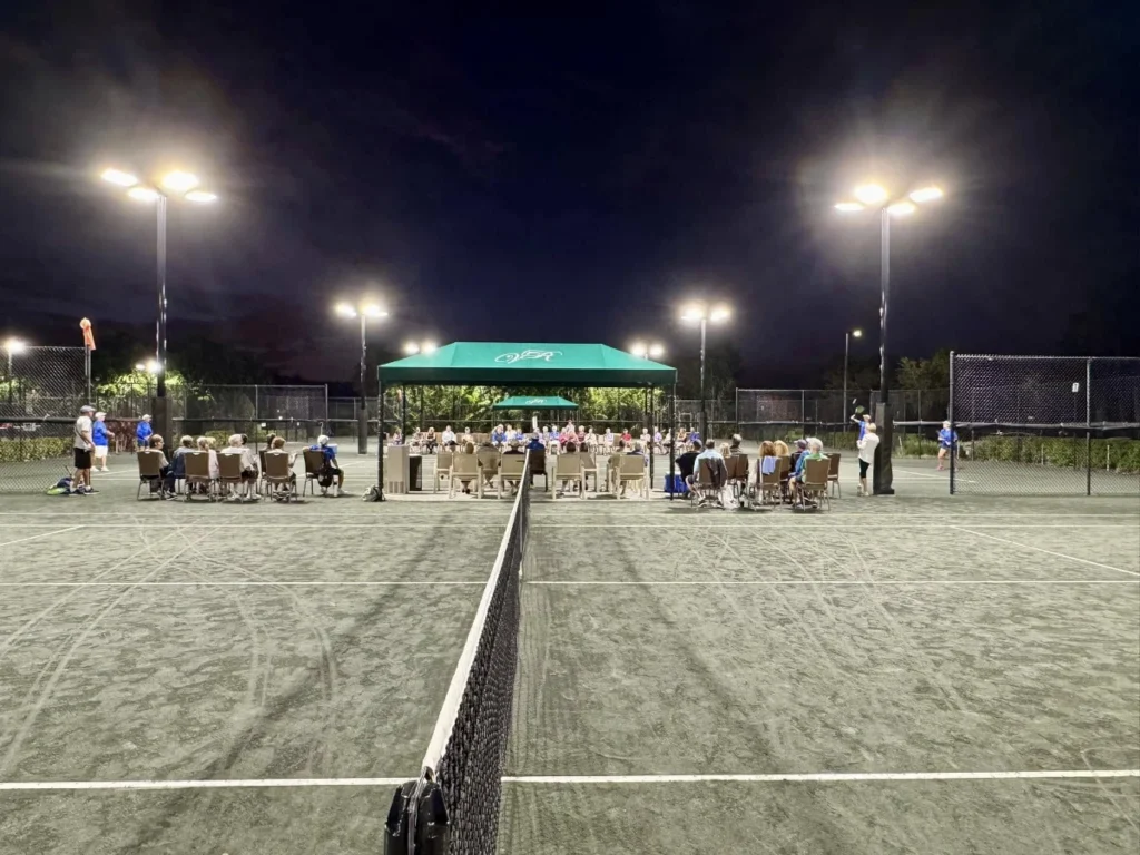 Evening tennis play on lighted Har-Tru courts at Valencia Reserve