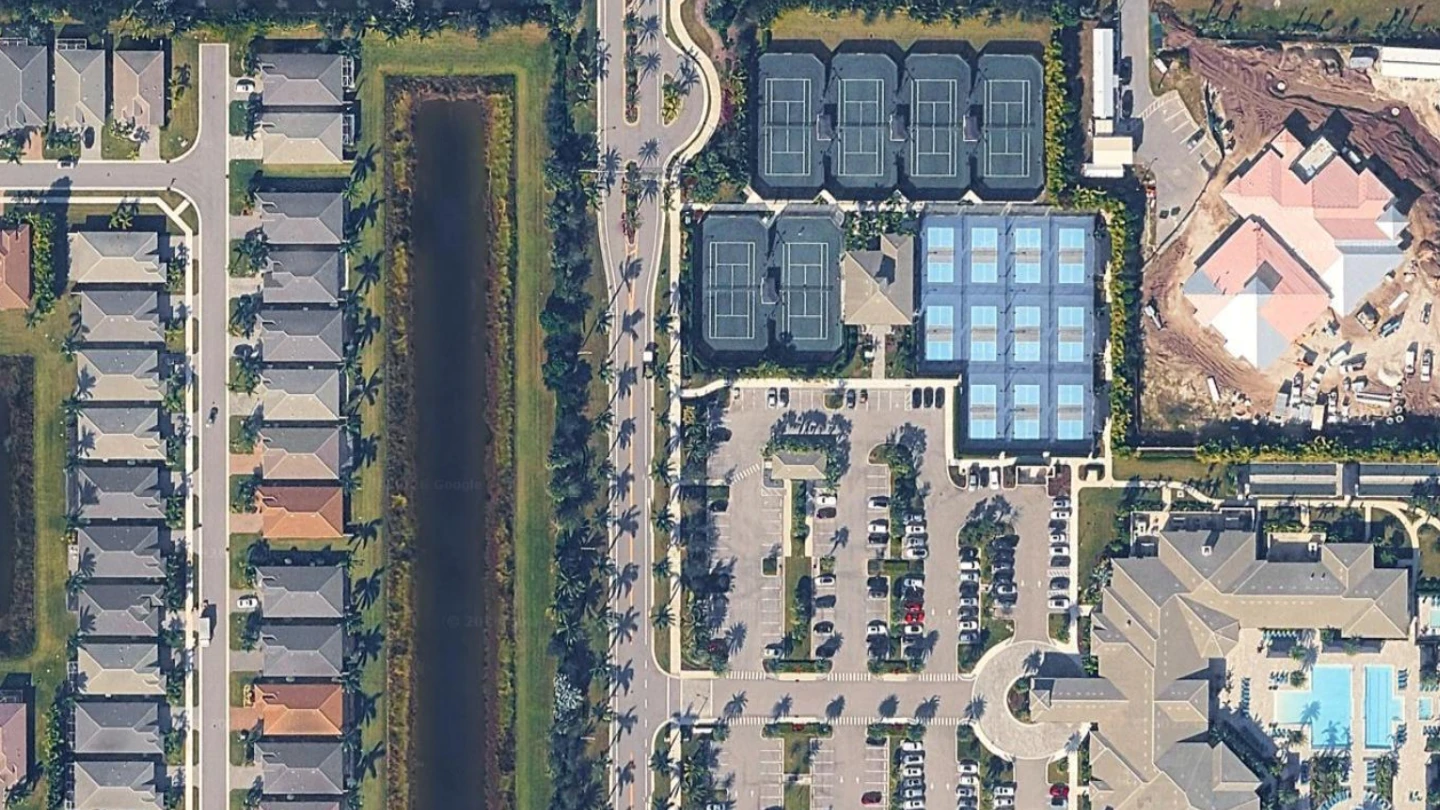 Aerial view of Valencia Sound showing the clubhouse, tennis courts, pickleball complex and homes in Boynton Beach