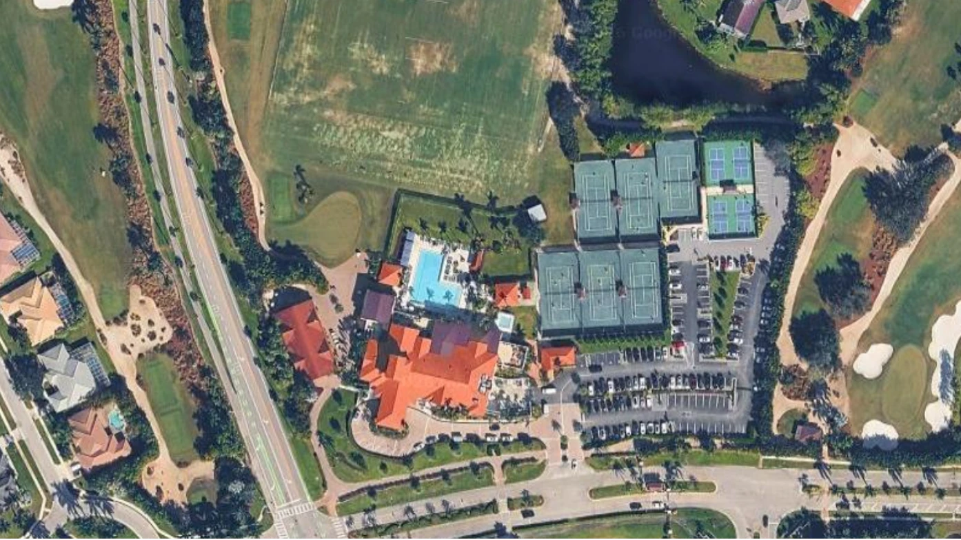 Aerial view of The Wanderers Club featuring the clubhouse, tennis courts, pickleball courts, resort pool, driving range, and championship golf course in Wellington, Florida